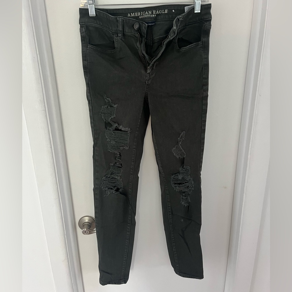 Dark green distressed American eagle jeans.